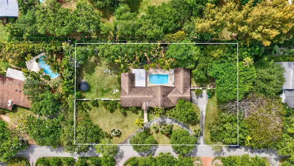 an aerial view of residential house with outdoor space and swimming pool