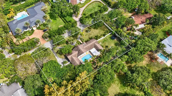 an aerial view of residential houses with yard