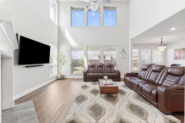 a living room with furniture a flat screen tv and a fireplace
