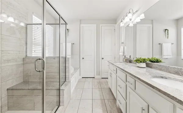 a bathroom with a sink a mirror and shower