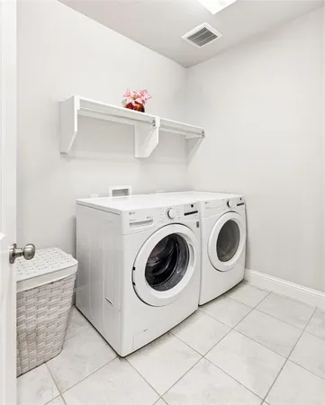 a bed sitting in a spacious bedroom next to a window