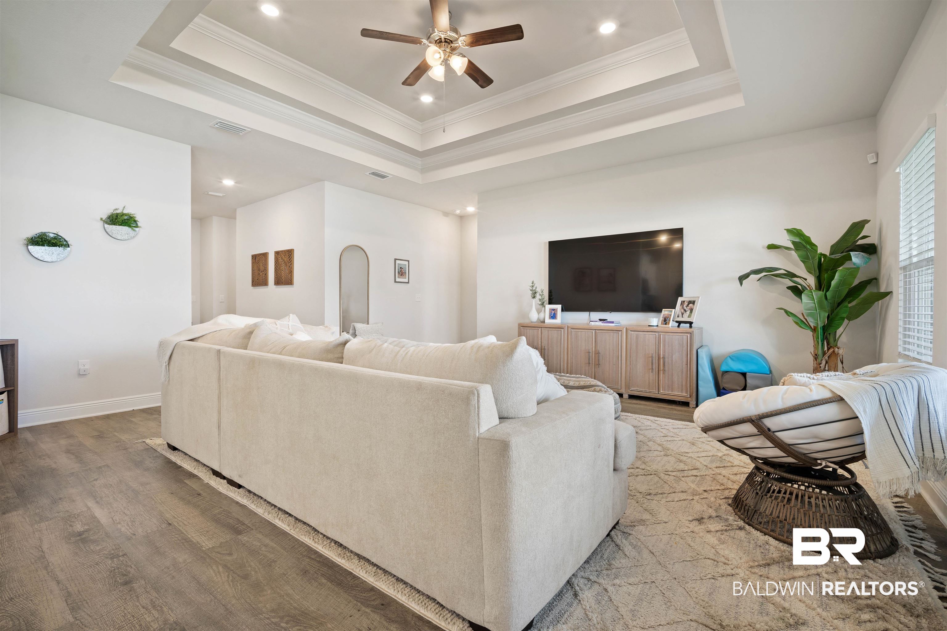 11021 Native Dancer Way Daphne, AL 36526 - Photo 5 of 35 Living area with a ceiling fan, wood finished floors, a raised ceiling, visible vents, and recessed lighting