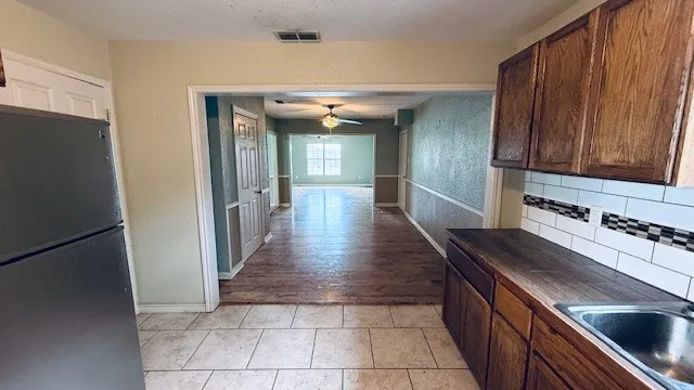 a view of a kitchen with a sink and dishwasher stove
