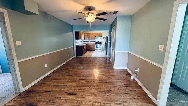 a view of a hallway with wooden floor