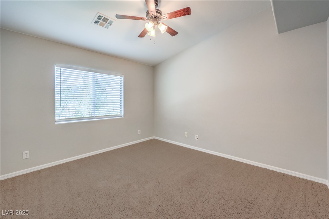 585 Foster Springs Road Las Vegas, NV 89148 - Photo 29 of 39 Spare room with carpet, ceiling fan, and lofted ceiling