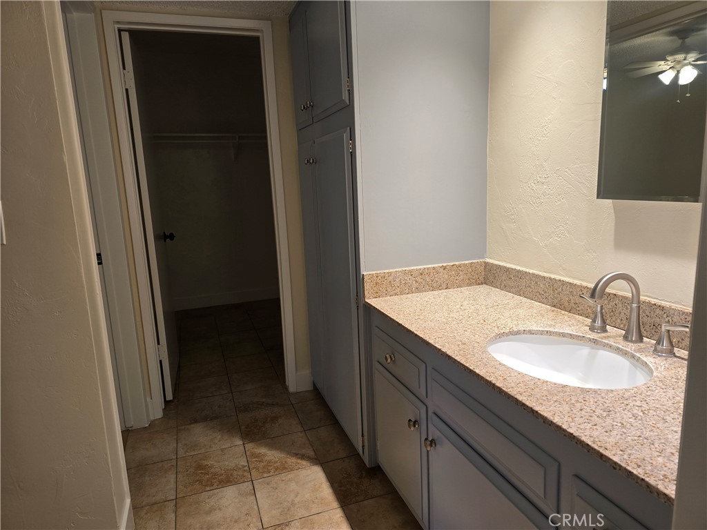 1350 West Lambert Road La Habra, CA 90631 - Photo 4 of 7 a bathroom with a granite countertop sink and a mirror