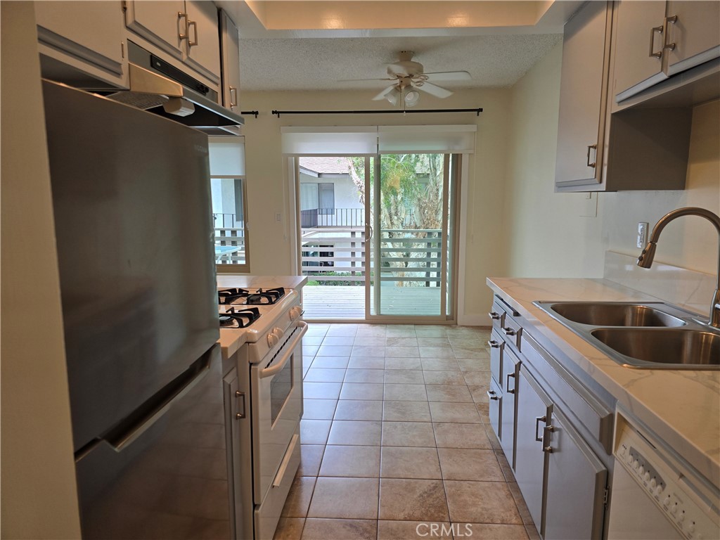 1350 West Lambert Road La Habra, CA 90631 - Photo 7 of 7 a kitchen with a sink a stove top oven and a refrigerator