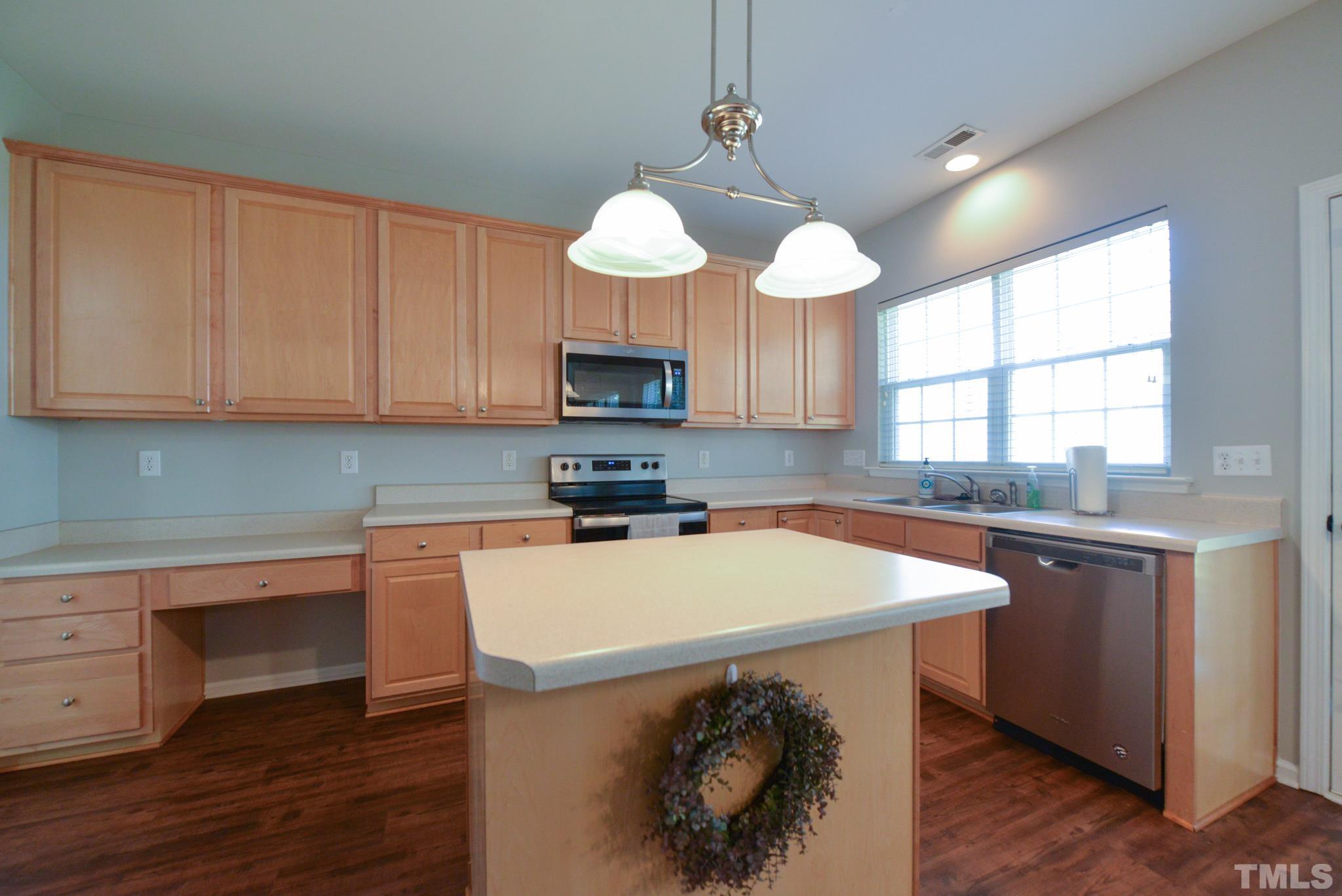 1513 Nealstone Way Raleigh, NC 27614 - Photo 11 of 30 a kitchen with a center island a counter space cabinets and a window