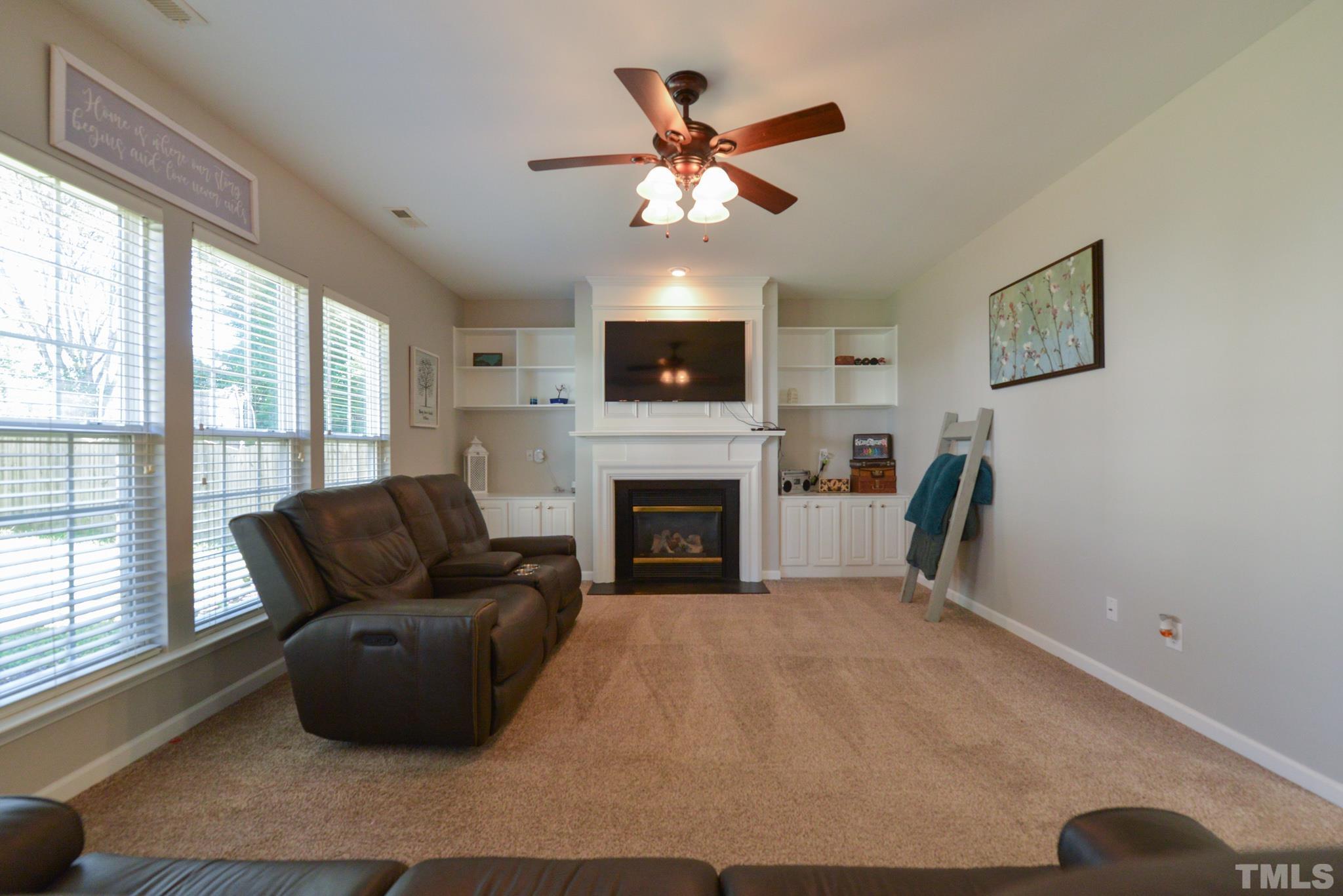 1513 Nealstone Way Raleigh, NC 27614 - Photo 13 of 30 a living room with furniture and a fireplace