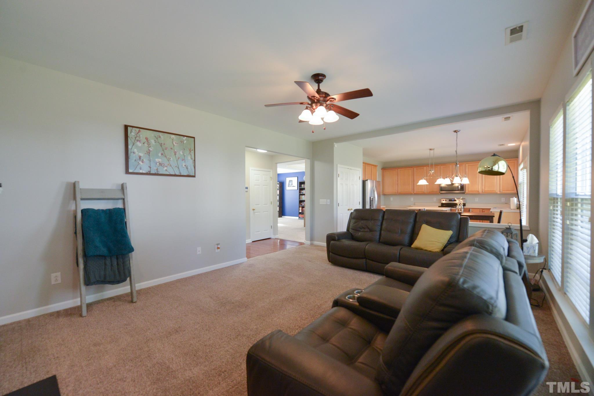 1513 Nealstone Way Raleigh, NC 27614 - Photo 16 of 30 a living room with furniture and a chandelier