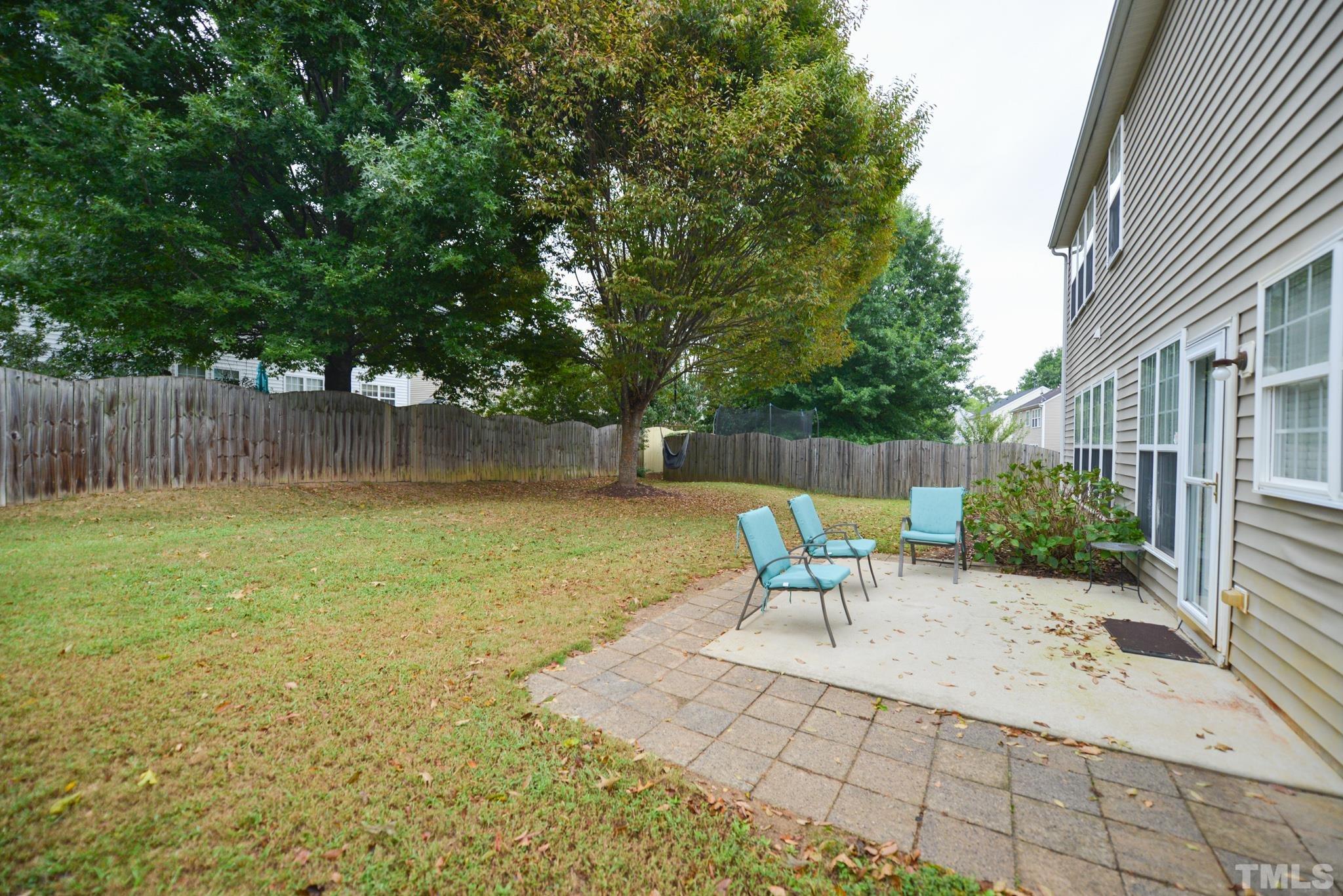 1513 Nealstone Way Raleigh, NC 27614 - Photo 3 of 30 a view of a patio with table and chairs and wooden fence
