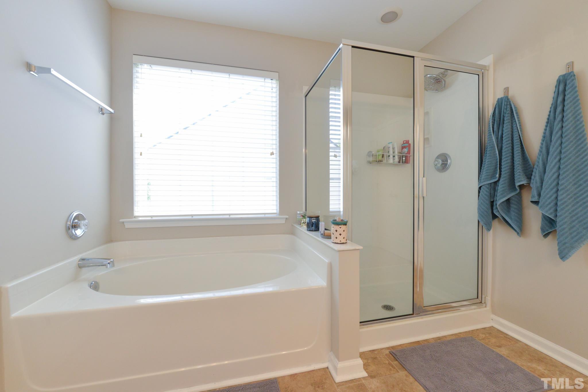 1513 Nealstone Way Raleigh, NC 27614 - Photo 22 of 30 a bathroom with a bathtub and a shower