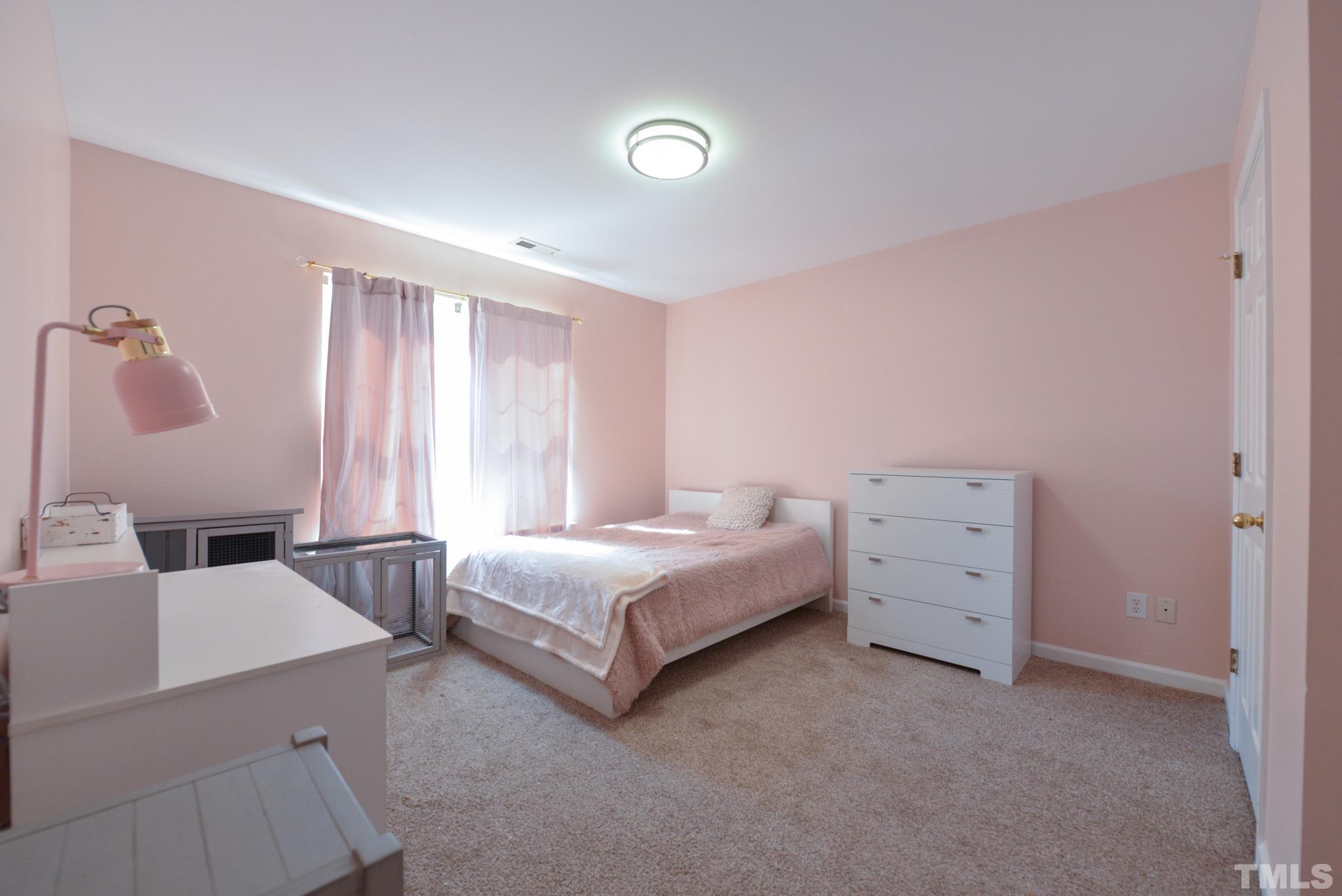 1513 Nealstone Way Raleigh, NC 27614 - Photo 23 of 30 a bedroom with a bed and a dresser