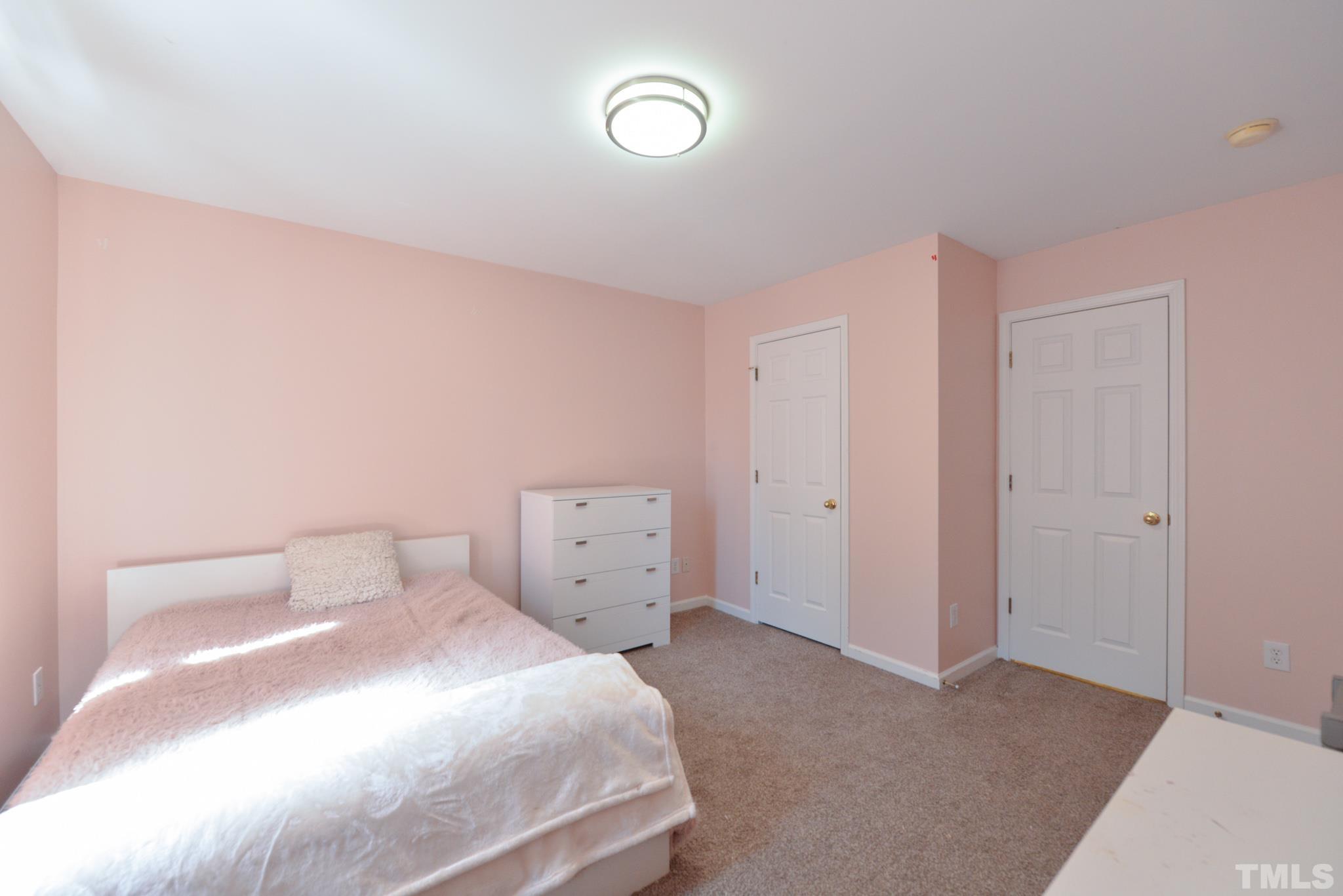 1513 Nealstone Way Raleigh, NC 27614 - Photo 24 of 30 a bedroom with a bed and a chandelier