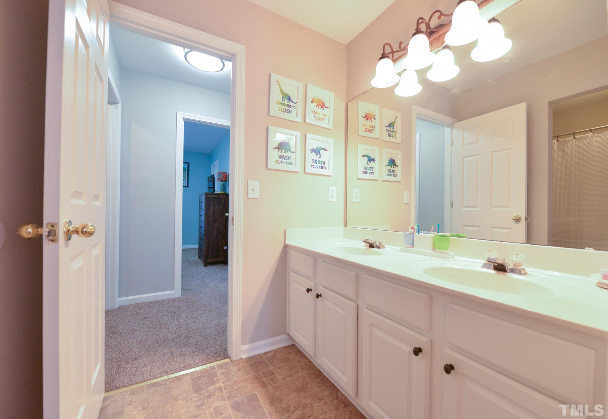 1513 Nealstone Way Raleigh, NC 27614 - Photo 25 of 30 a spacious bathroom with a double vanity sink mirror and double