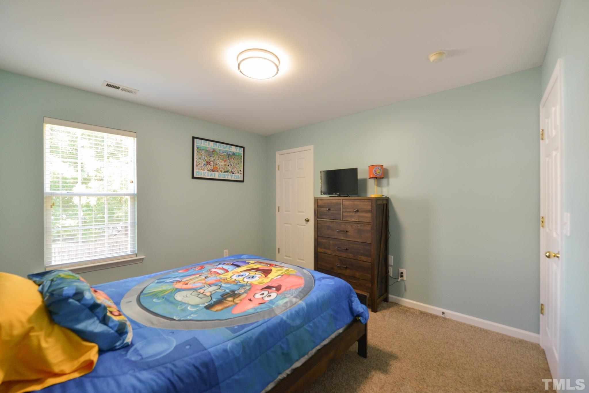 1513 Nealstone Way Raleigh, NC 27614 - Photo 26 of 30 a bed room with a bed and a chair