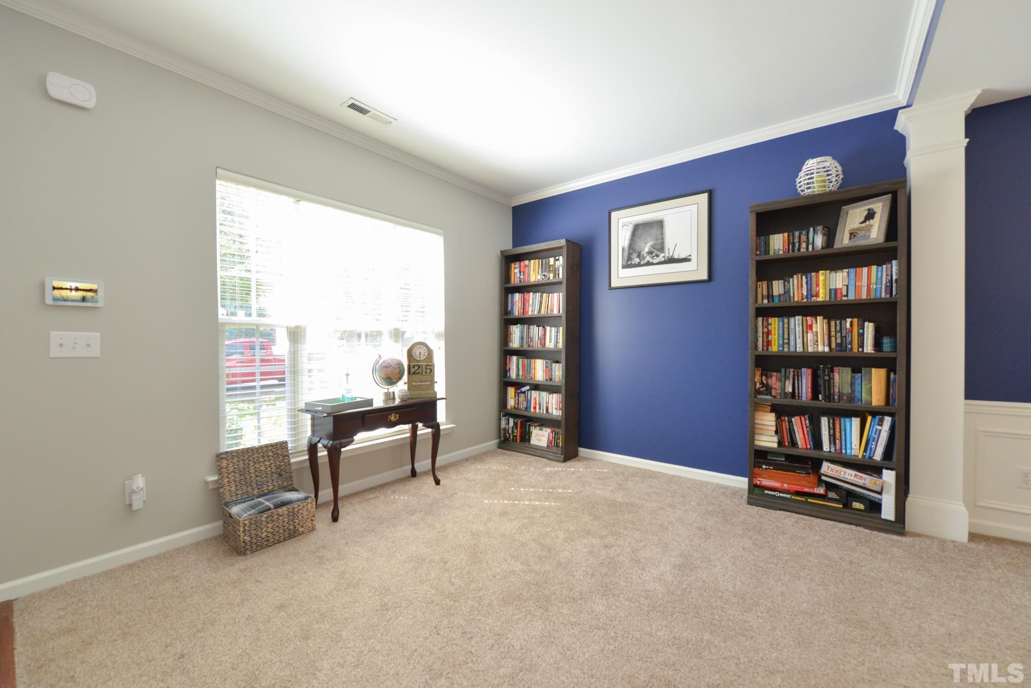 1513 Nealstone Way Raleigh, NC 27614 - Photo 5 of 30 a view of a livingroom with furniture and a bookshelf