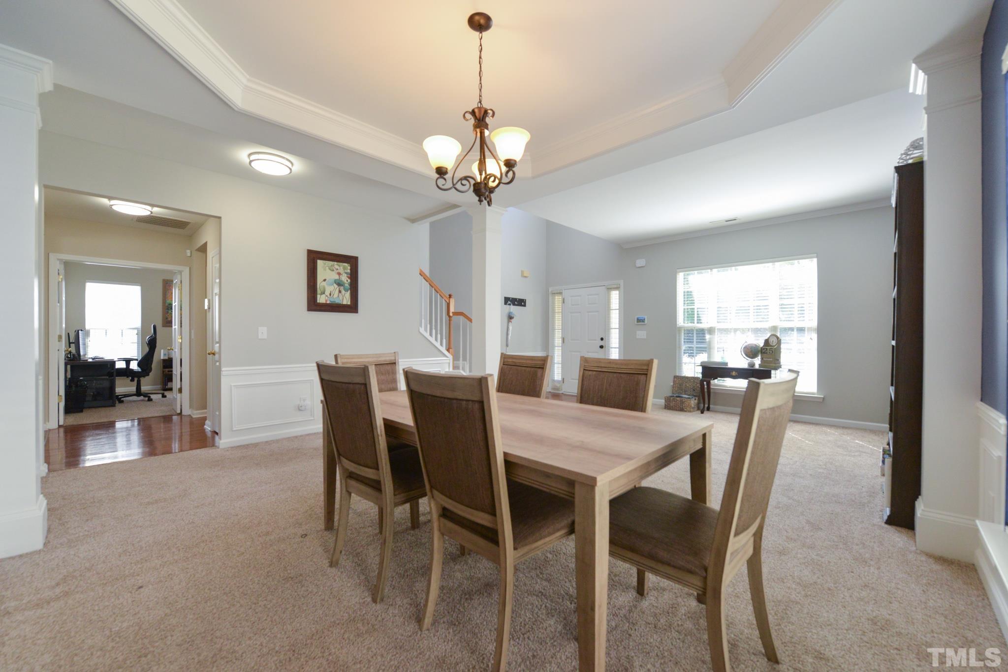 1513 Nealstone Way Raleigh, NC 27614 - Photo 7 of 30 a view of a dining room with furniture and a chandelier