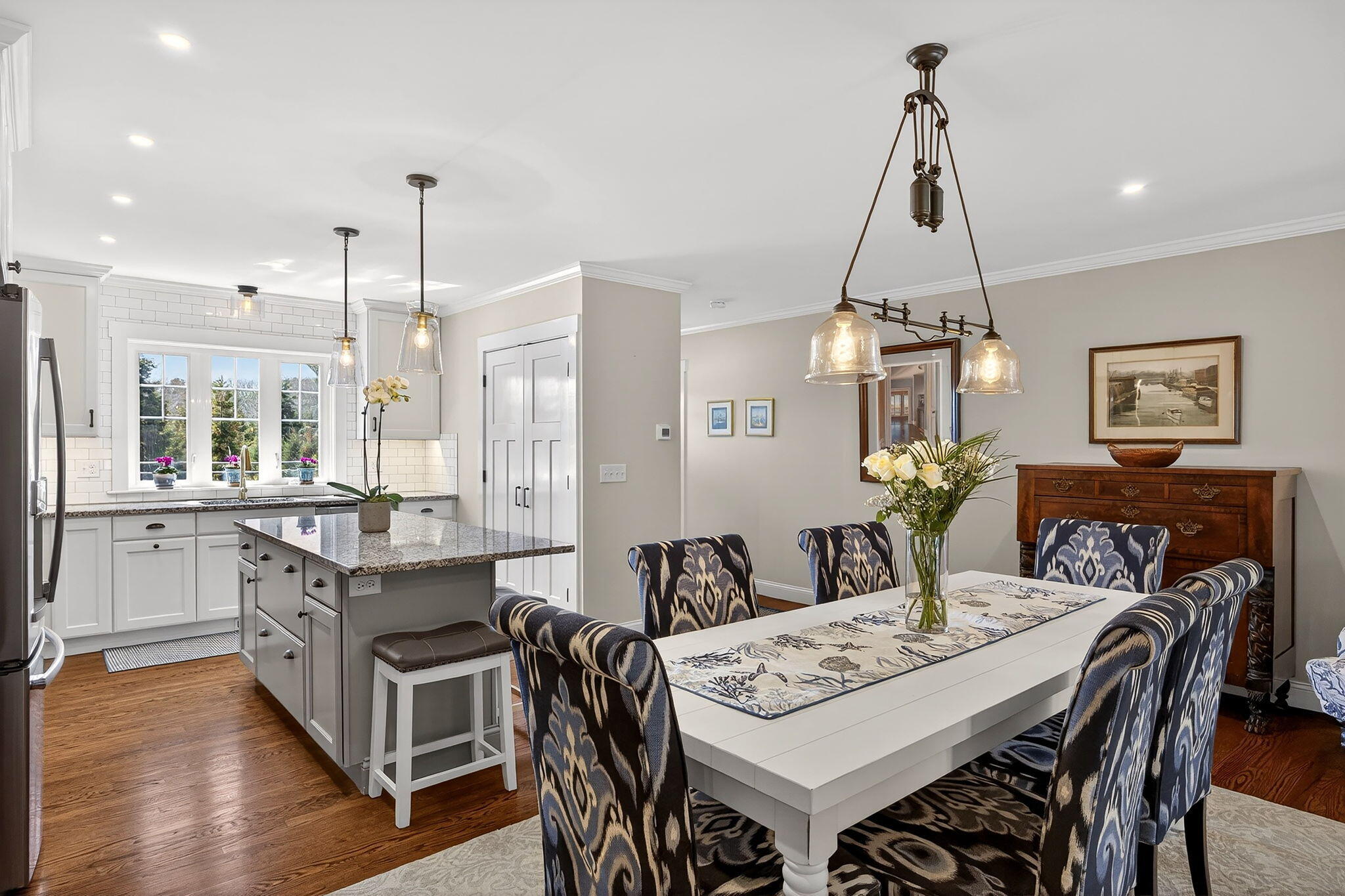 176 Bumps River Road Osterville, MA 02655 - Photo 9 of 54 a view of a dining room and livingroom with furniture wooden floor a chandelier