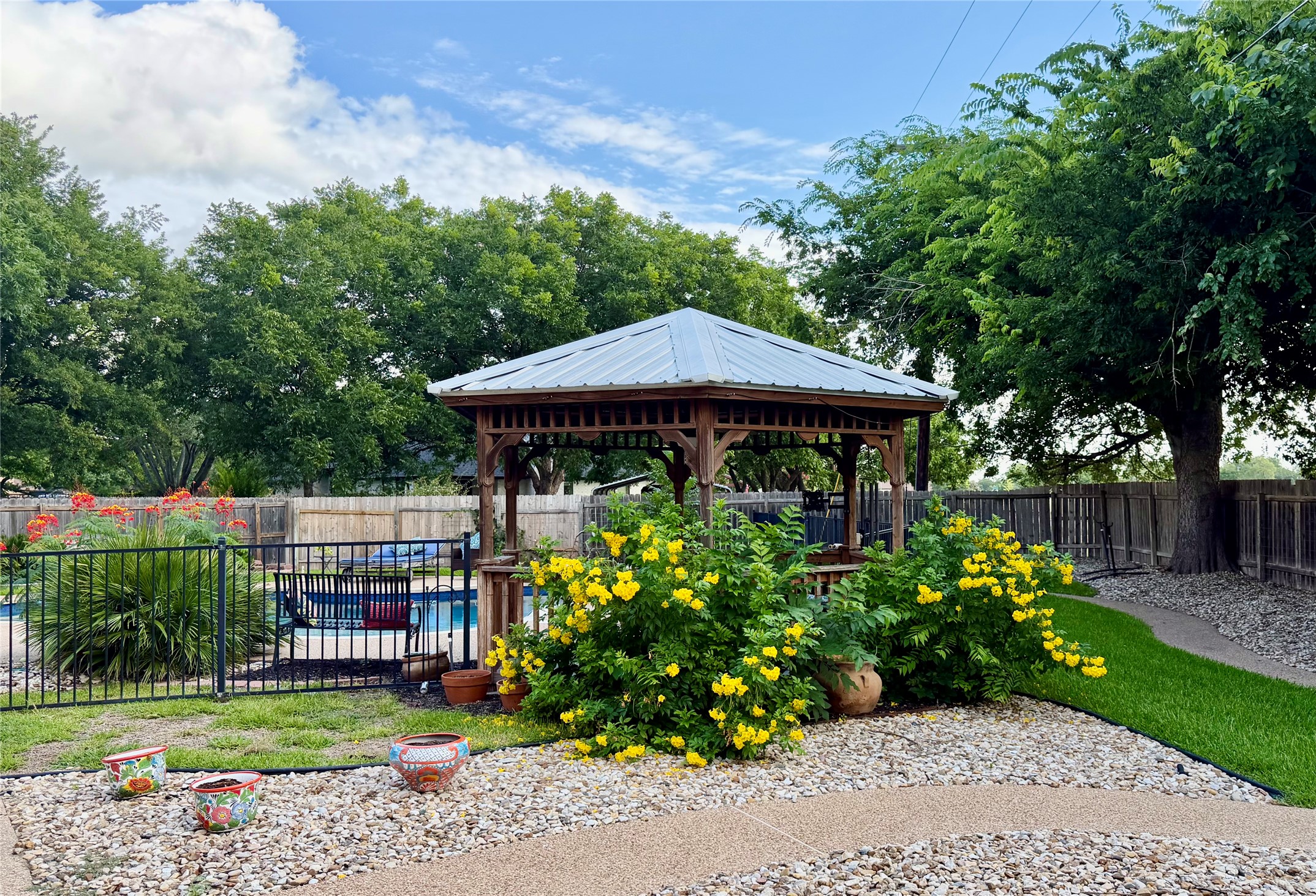 13 Oak View Round Rock, TX 78664 - Photo 24 of 30 Relax in this inviting gazebo, nestled among vibrant landscaping and overlooking a refreshing pool.