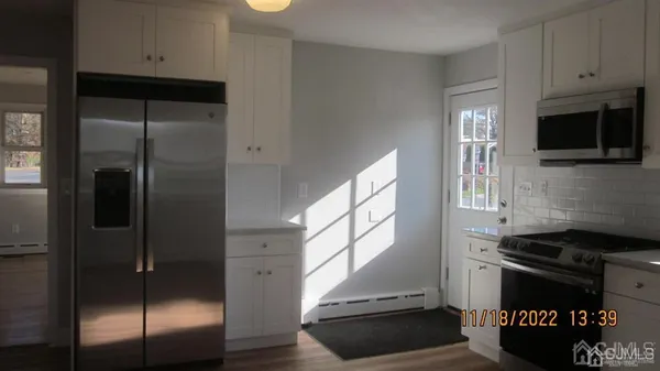 a kitchen with stainless steel appliances granite countertop a refrigerator and a stove top oven