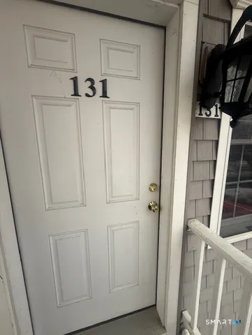 a view of a closet with wooden floor