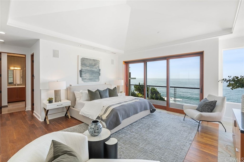 11 Camel Point Drive Laguna Beach, CA 92651 - Photo 18 of 67 a spacious bedroom with a bed and glass window