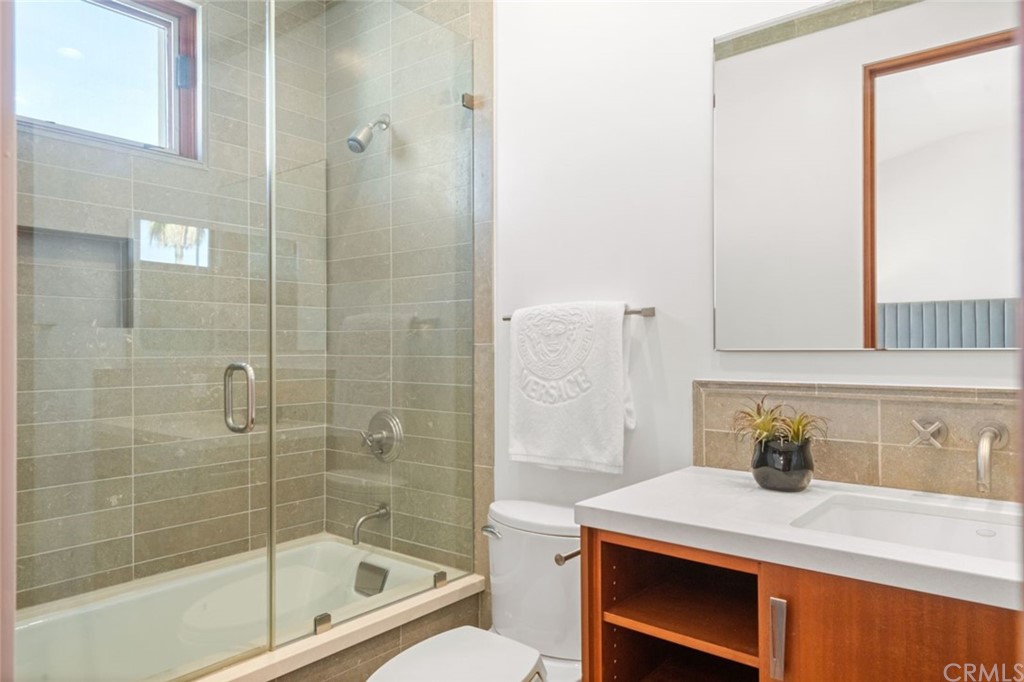11 Camel Point Drive Laguna Beach, CA 92651 - Photo 25 of 67 a bathroom with a sink and a mirror
