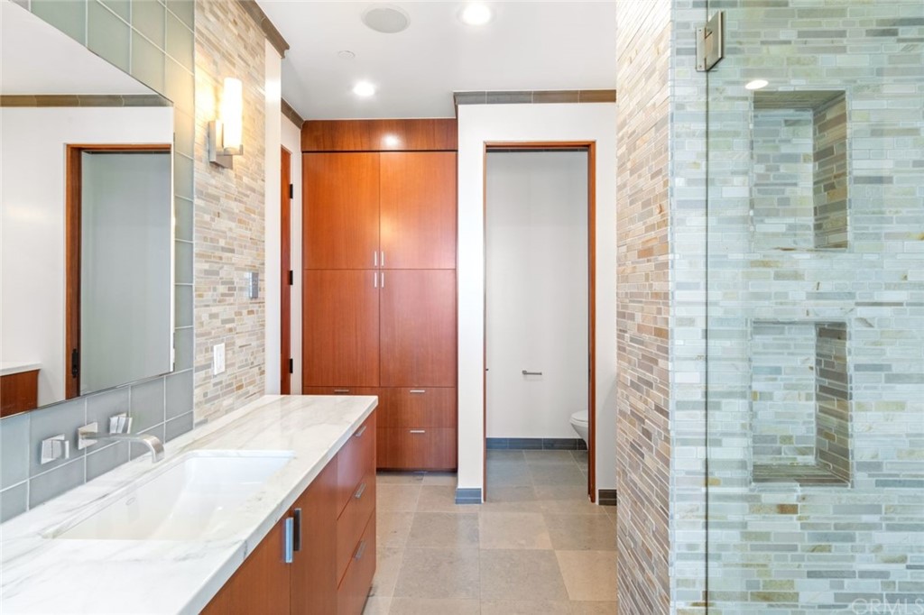 11 Camel Point Drive Laguna Beach, CA 92651 - Photo 26 of 67 a bathroom with a granite countertop sink a shower and a mirror