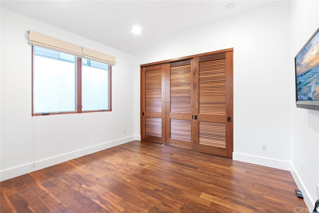 11 Camel Point Drive Laguna Beach, CA 92651 - Photo 33 of 67 an empty room with wooden floor and windows