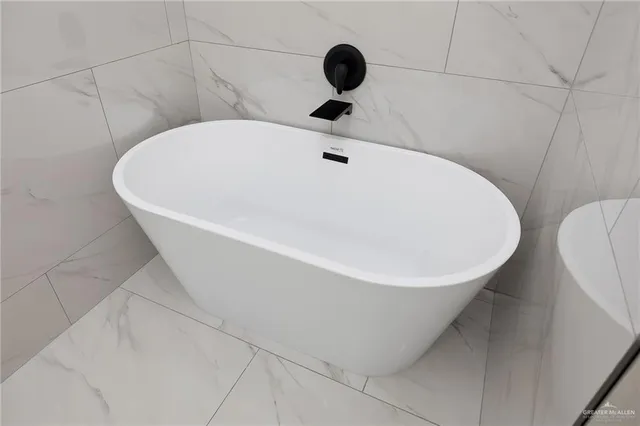 a white bath tub sitting in a bathroom
