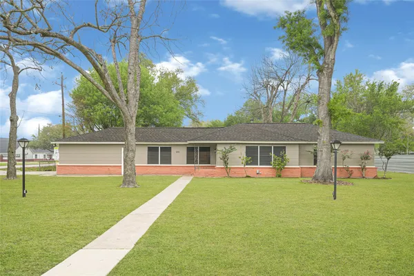 a view of house with a backyard