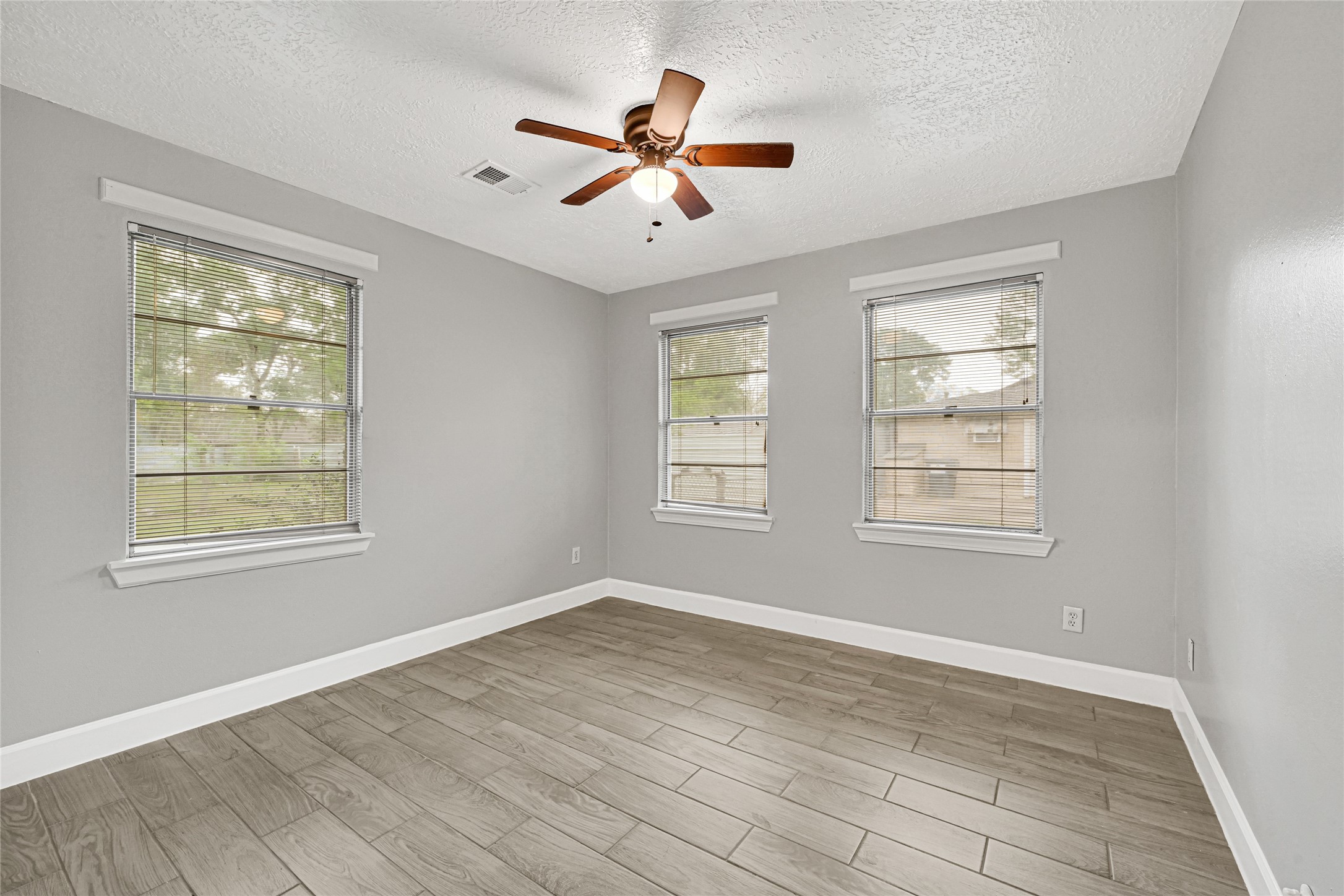 205 Grammar Road Houston, TX 77047 - Photo 11 of 26 a view of an empty room with wooden floor and a window