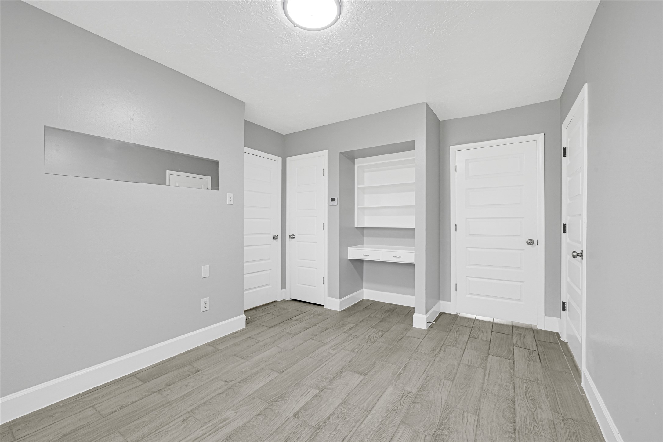 205 Grammar Road Houston, TX 77047 - Photo 12 of 26 a view of empty room with wooden floor