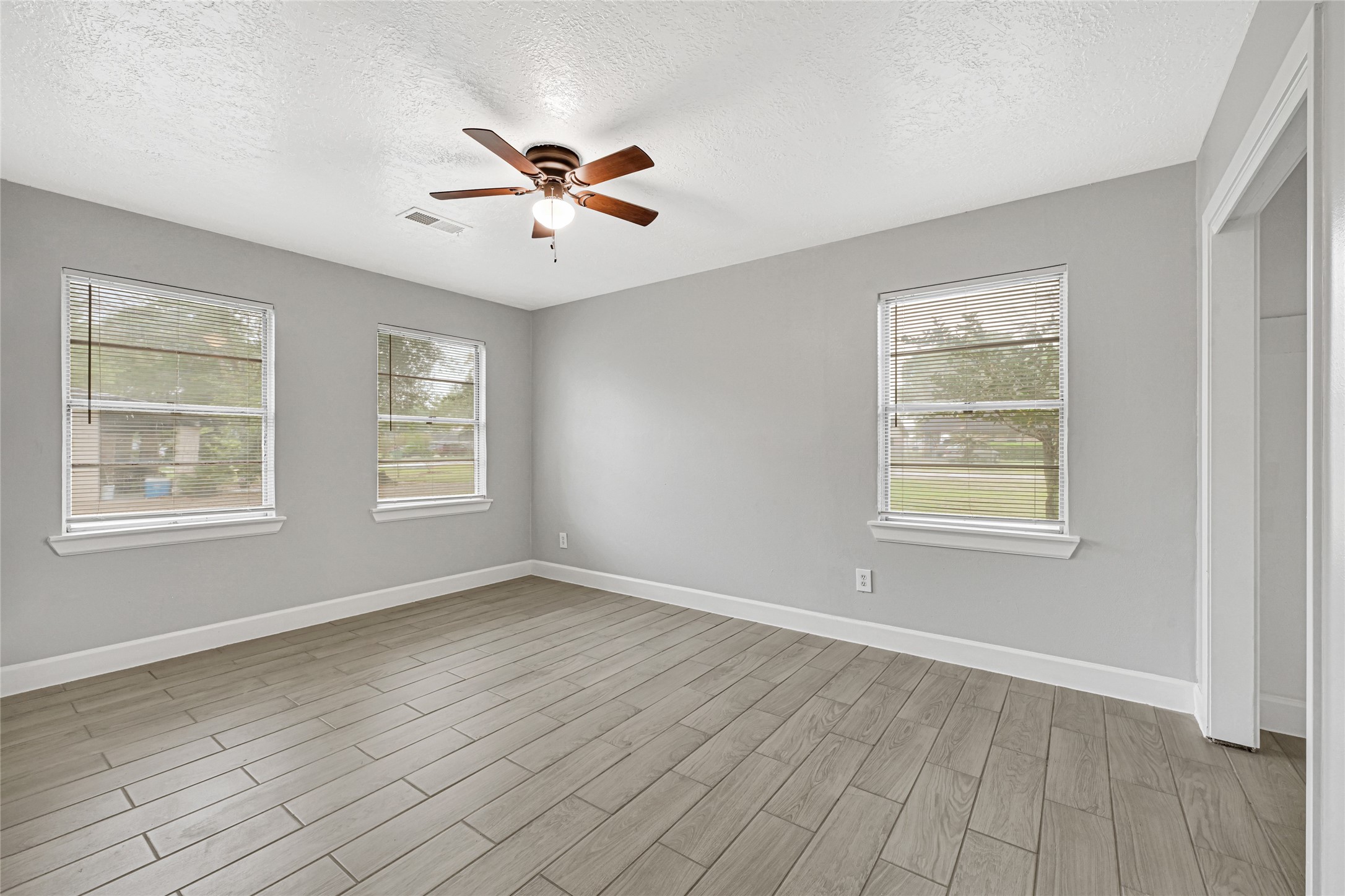 205 Grammar Road Houston, TX 77047 - Photo 14 of 26 a view of an empty room with wooden floor and a window