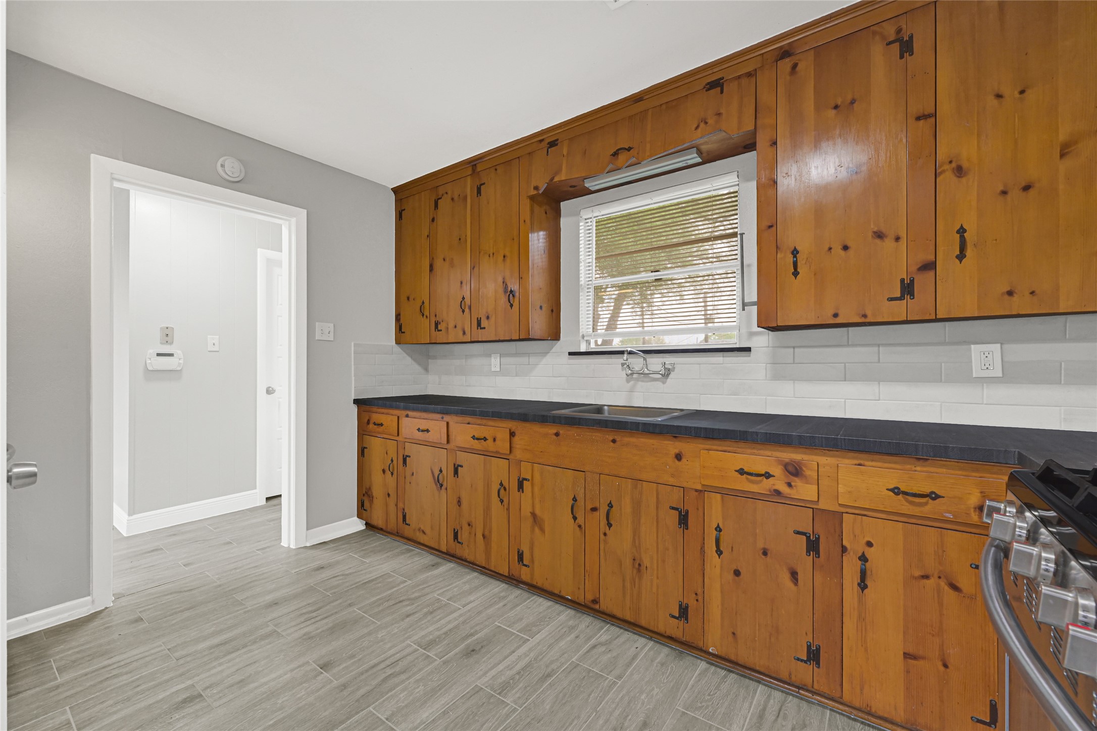 205 Grammar Road Houston, TX 77047 - Photo 8 of 26 a kitchen with wooden cabinets