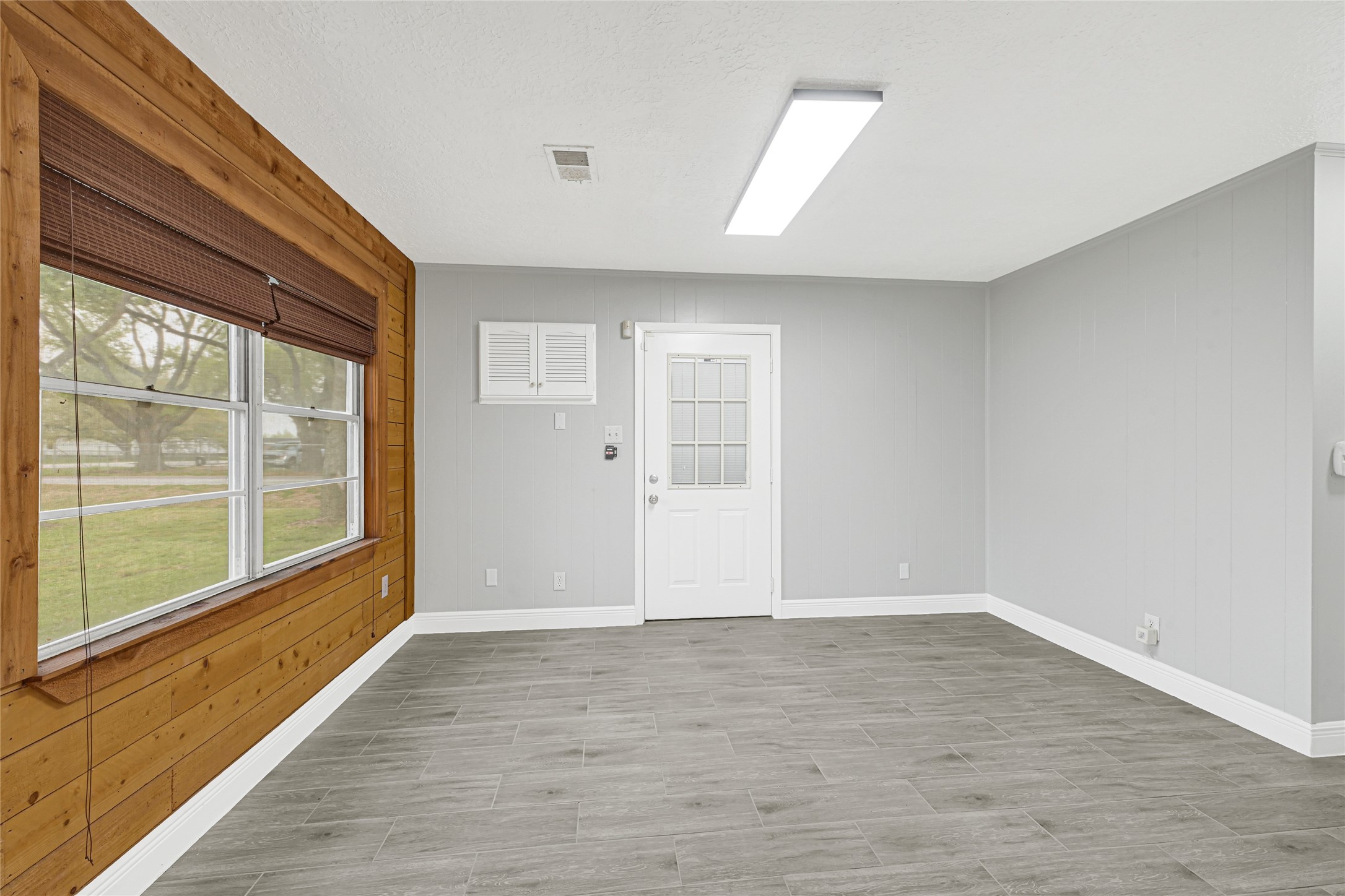205 Grammar Road Houston, TX 77047 - Photo 10 of 26 a view of an empty room with wooden floor and a window