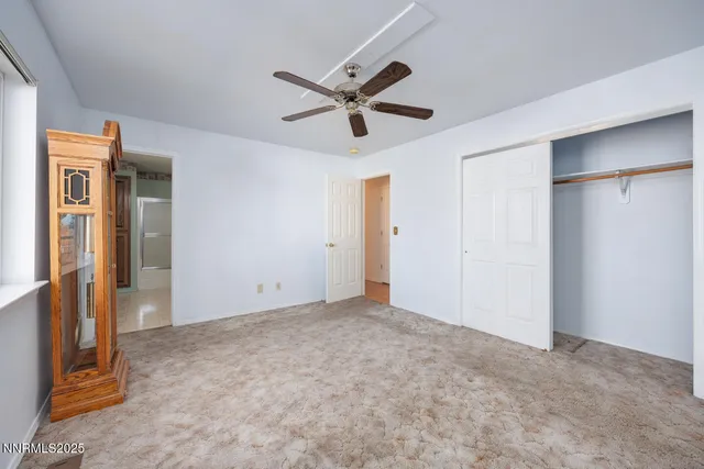 a view of empty room with ceiling fan