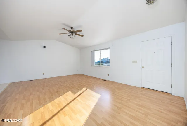 a view of a room with cabinet and ceiling fan