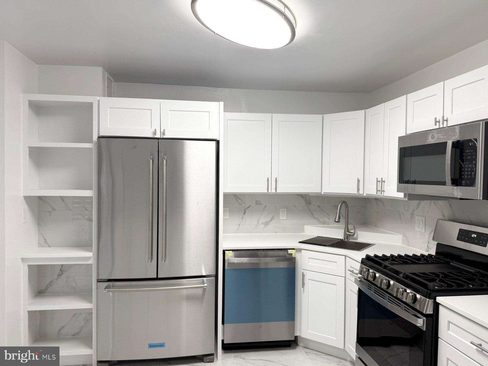 606 Cooper Landing Road, Unit A3K Cherry Hill, NJ 08002 - Photo 5 of 18 a kitchen with a refrigerator and a stove top oven