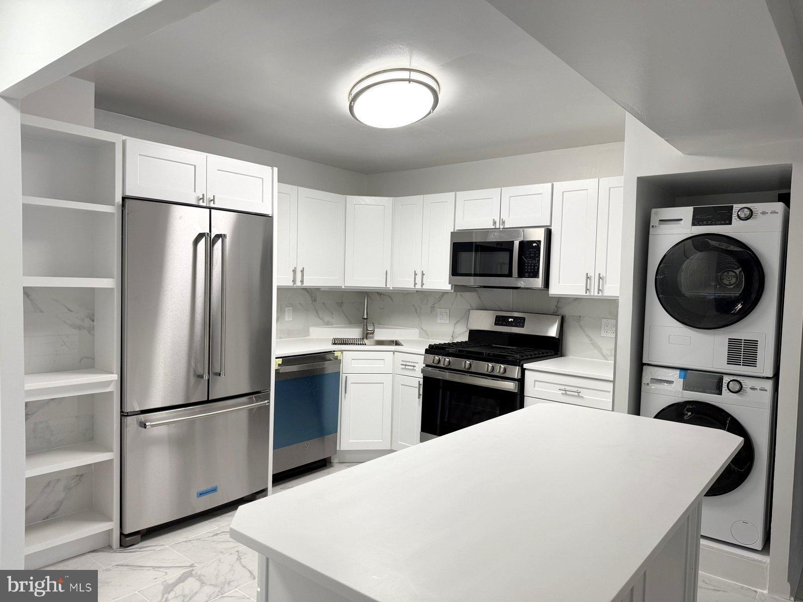 606 Cooper Landing Road, Unit A3K Cherry Hill, NJ 08002 - Photo 6 of 18 a kitchen with a refrigerator stove and microwave