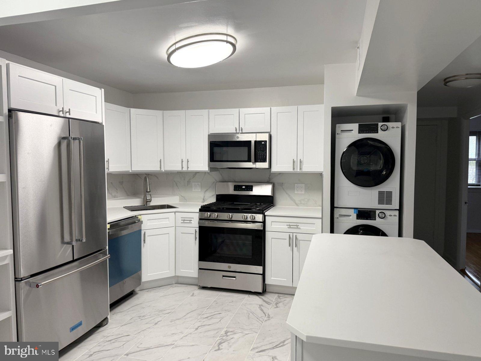 606 Cooper Landing Road, Unit A3K Cherry Hill, NJ 08002 - Photo 7 of 18 a kitchen with stainless steel appliances granite countertop a stove a refrigerator and a microwave