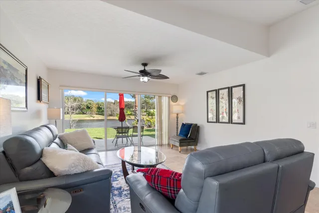 a living room with furniture and kitchen view