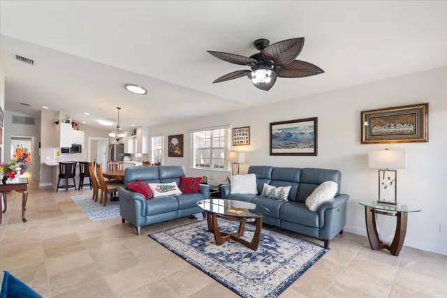 a dining room with furniture a rug and a chandelier