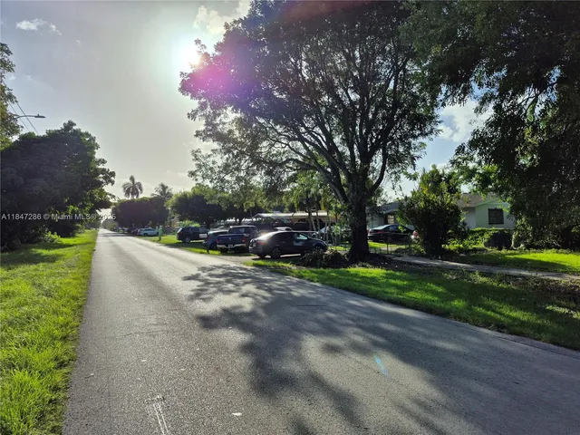 a view of street with parked cars
