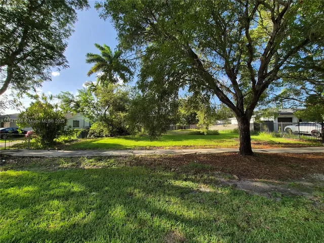 a view of yard with swimming pool and trees