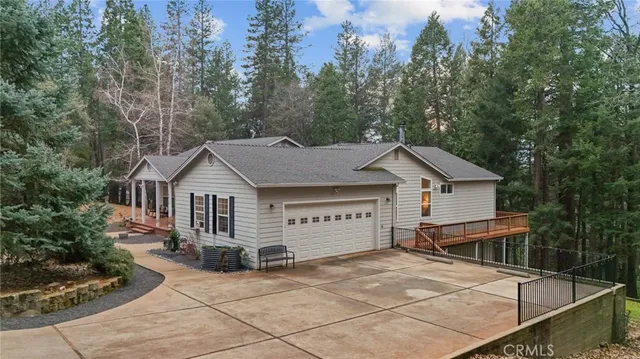 a view of a house with a backyard and trees