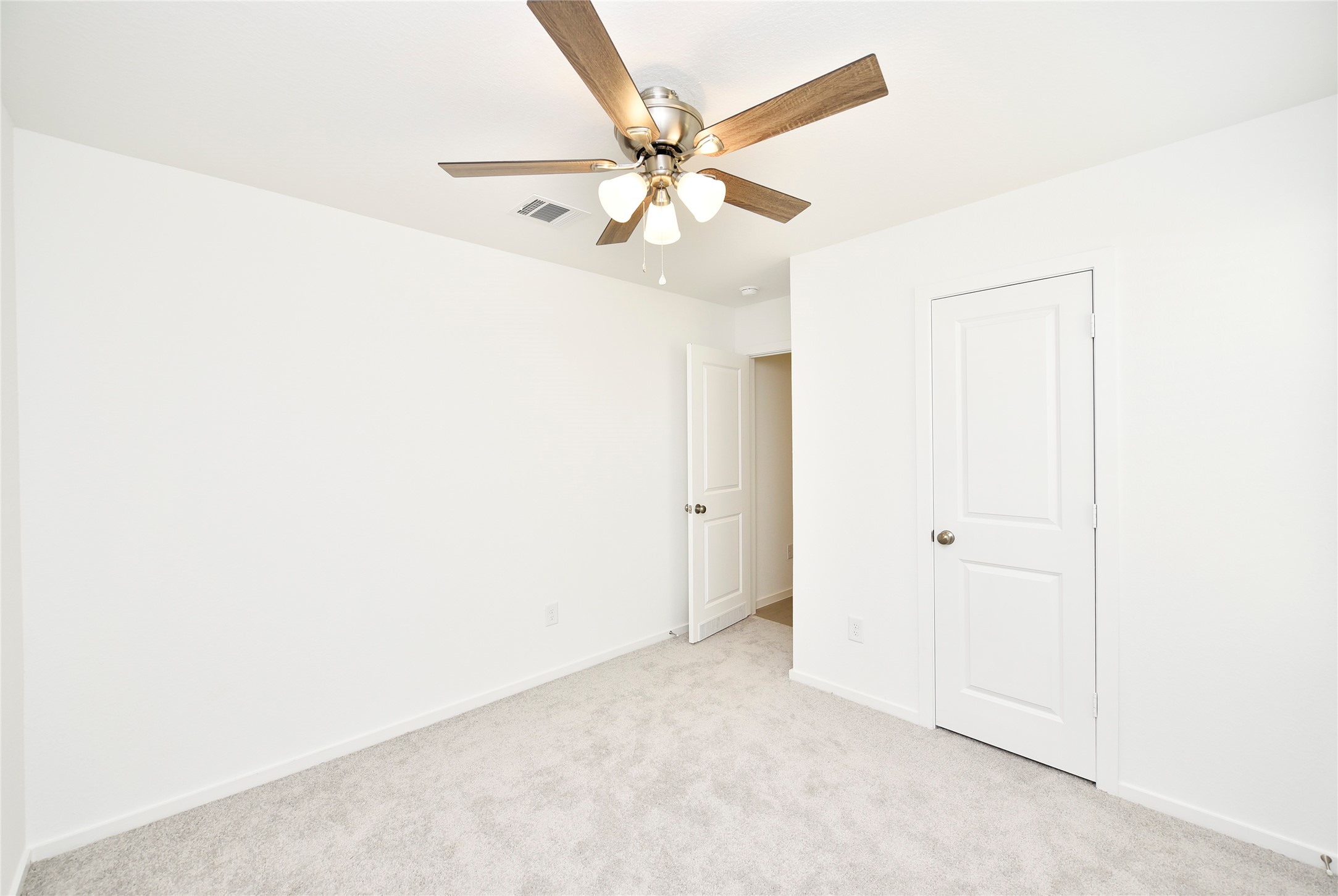 10218 Prairie Dunes Lane Cleveland, TX 77327 - Photo 25 of 32 an empty room with a ceiling fan and a window