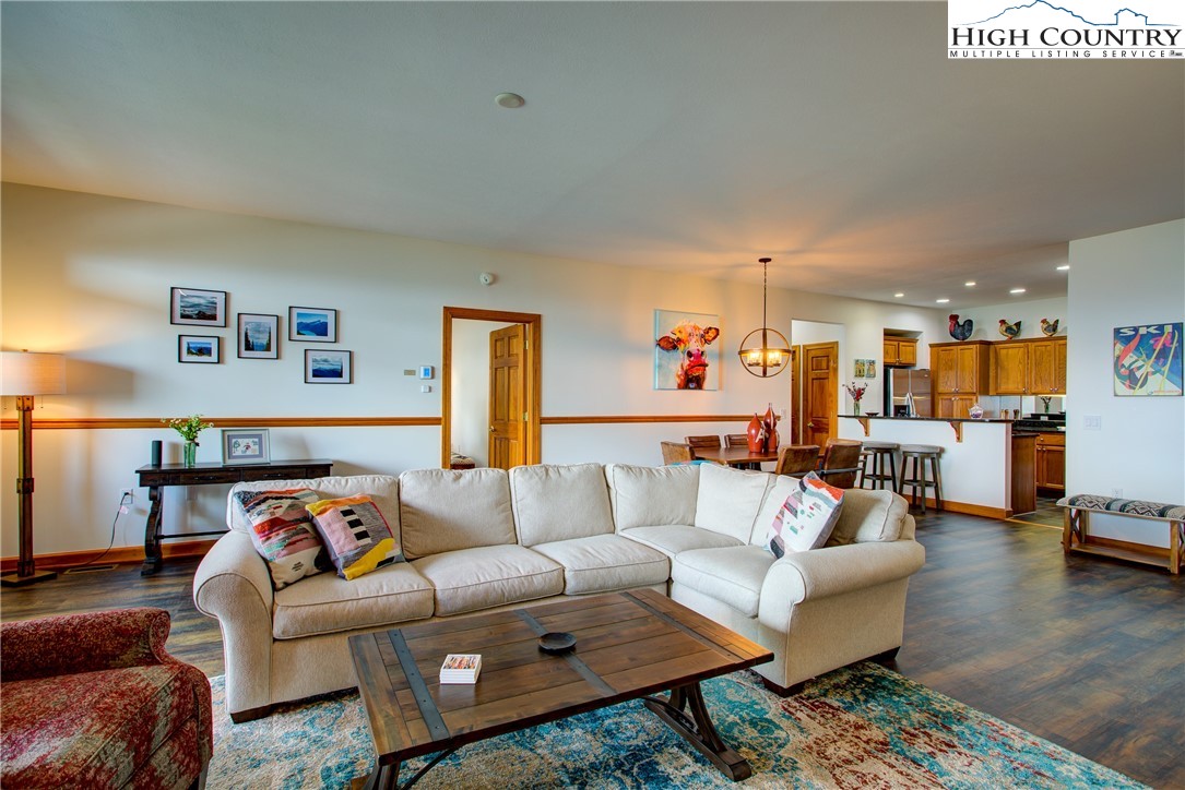 202 Pleasant View, Unit 9D Sugar Mountain, NC 28604 - Photo 11 of 48 a living room with furniture and a view of kitchen