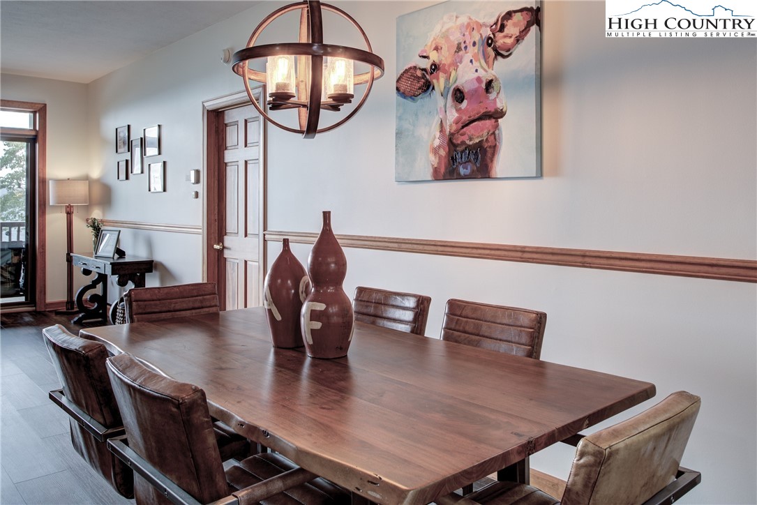 202 Pleasant View, Unit 9D Sugar Mountain, NC 28604 - Photo 21 of 48 a view of a dining room with furniture and chandelier
